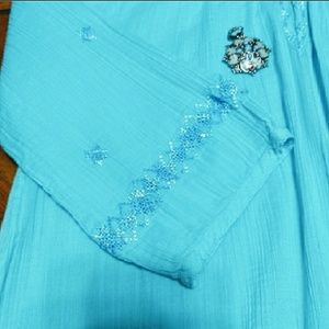 Beautiful turquoise colored blouse.
